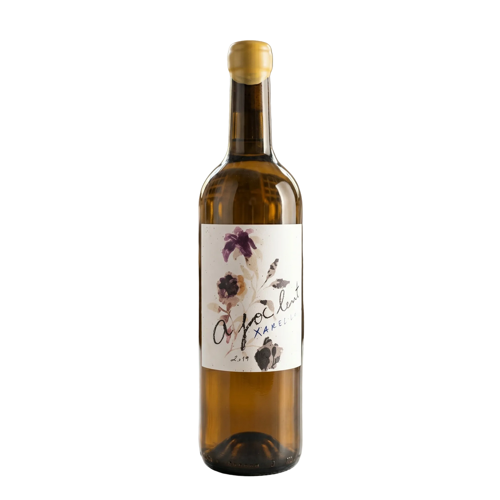 Wine bottle with a decorative label on a table in a wine cellar.