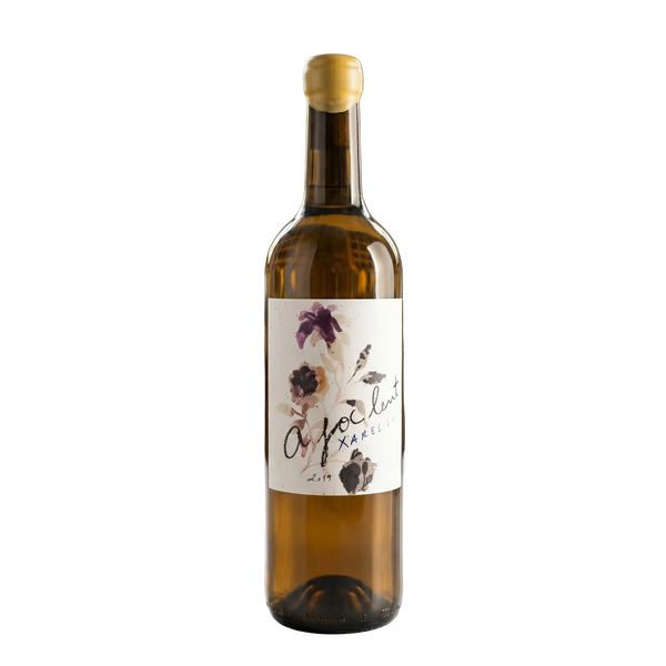 Wine bottle with a decorative label on a table in a wine cellar.