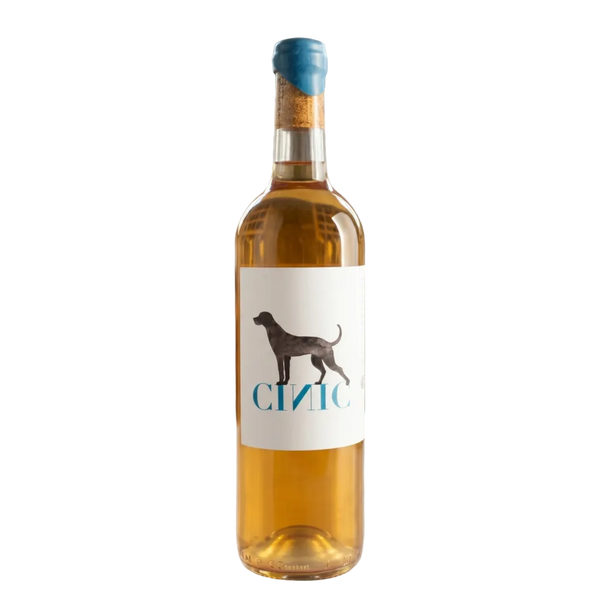 Wine bottle with a label featuring a dog silhouette in a wine cellar setting