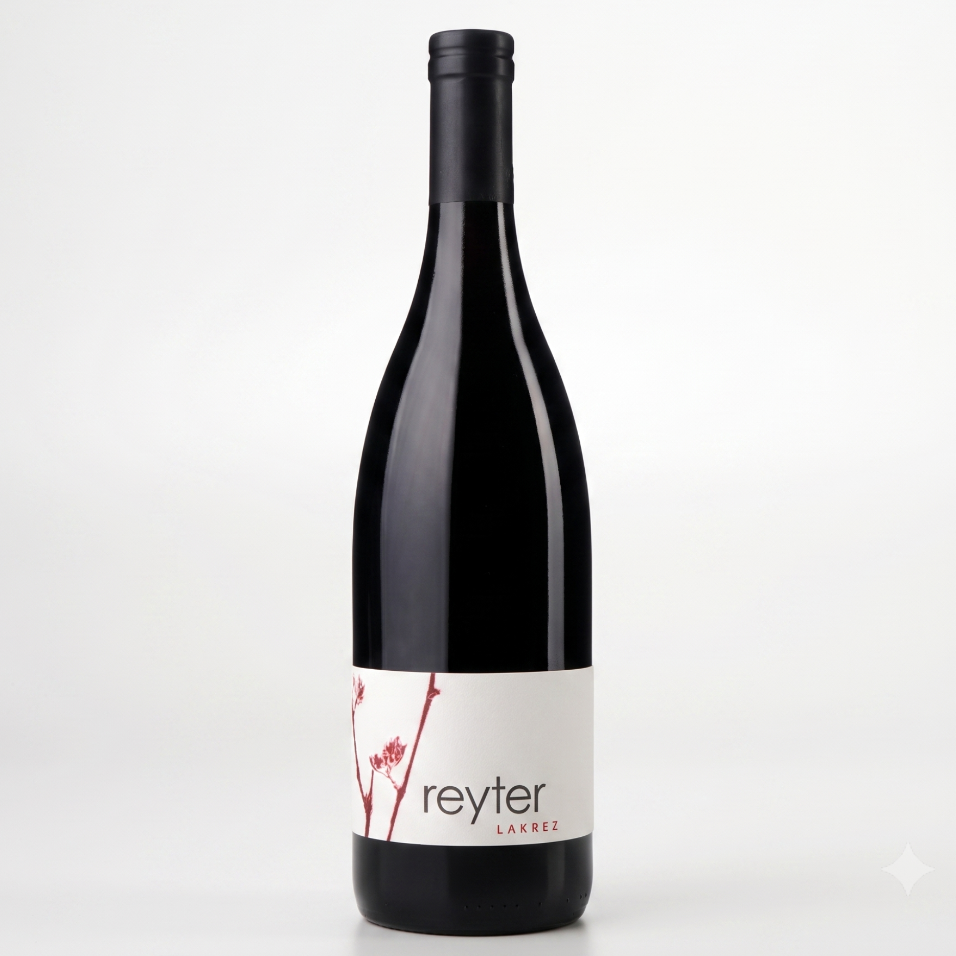 A bottle of Reyter Lakrez from the Loire Valley, featuring a dark glass body, black foil, and a white label with red floral accents, set against a clean white background.