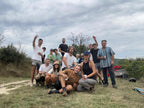 Group of people posing outdoors afer grape harvesting at Malia's