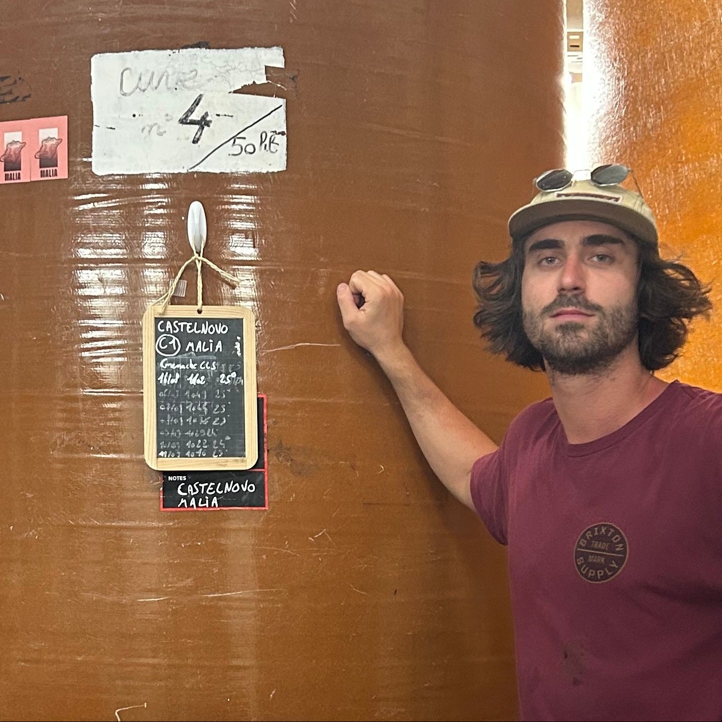 Tommaso Castelnovo standing next to a large wooden door with a sign on it