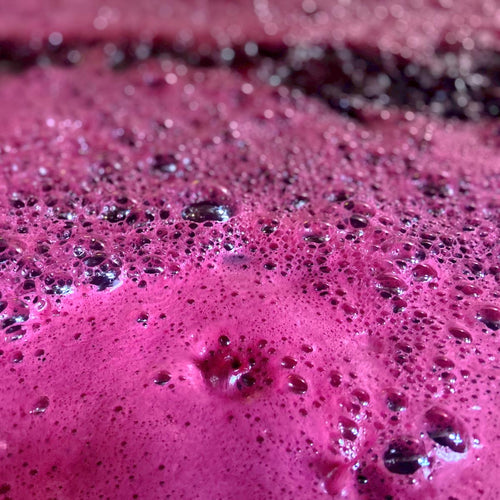 Close-up of a pinkish-purple wine with bubbles