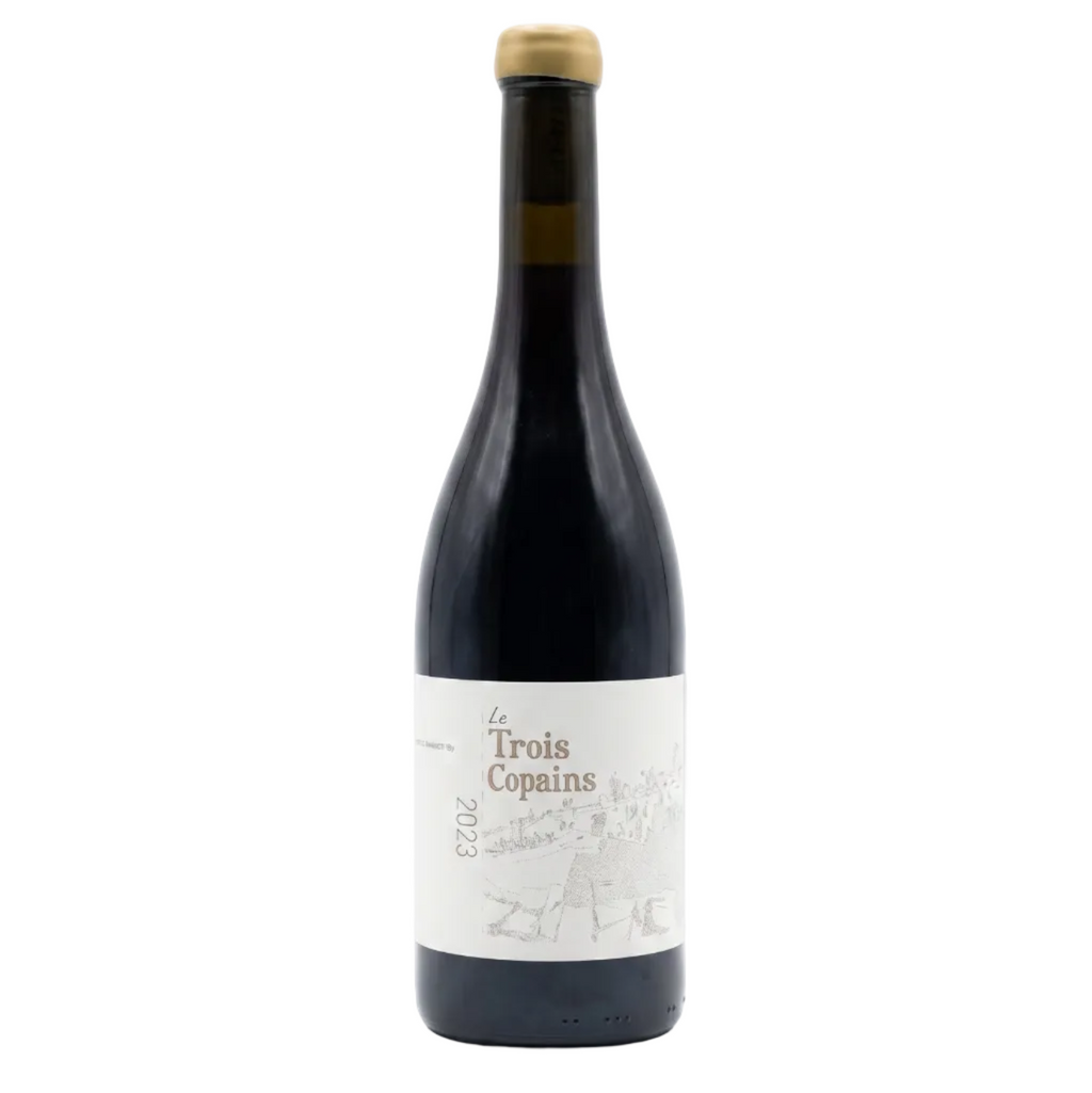 A bottle of Trois Copains 2023 red wine, featuring a dark glass bottle with a cream-colored label and a gold foil cap, set against a plain white background.