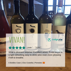 Bottles of wine with visible labels on a wooden surface, featuring a rating overlay from Judge.me Reviews.