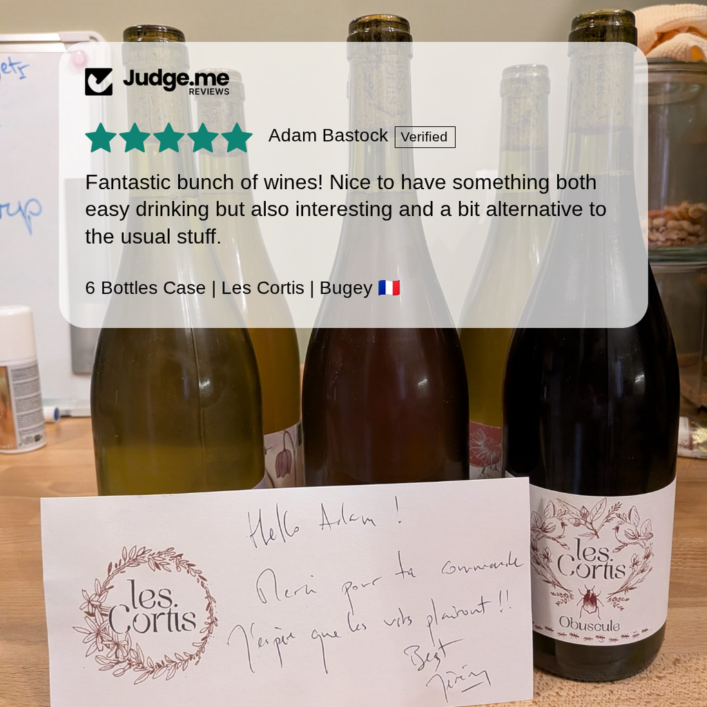 Wine bottles with labels and a handwritten card on a table, with 'Judge.me' review overlay.